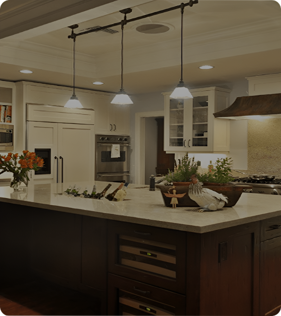 Modern kitchen with island and pendant lights.